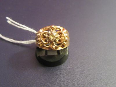 a gold ring with a black stone on a string