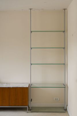 une étagère en verre dans un coin de la pièce