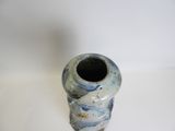 a blue and white vase sitting on a white surface