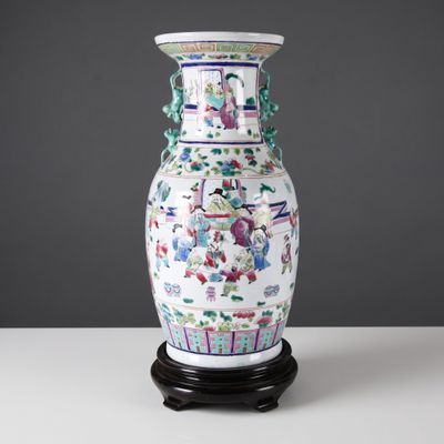 a vase that has a picture of people on it