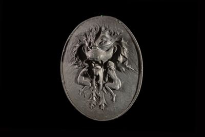 a close up of a silver medallion with a dragon on it