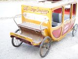 an old fashioned horse drawn carriage on the side of the road