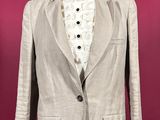 the jacket is made of linen and has buttons on the lapel