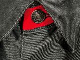 a close up of a black jacket with a red tie