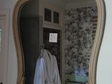 a mirror hanging on the wall above a sink