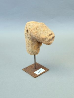 sculpture représentant une tête d'ours sur un socle en bois