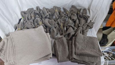 a lot of cloths that are sitting on a table