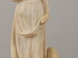 marble statue of a woman with a dog on a table