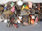 a pile of assorted key chains on a table