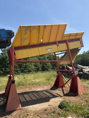 a picture of a large yellow and red dumpster