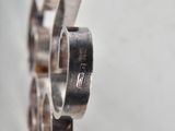 a close up of a silver ring on a white surface