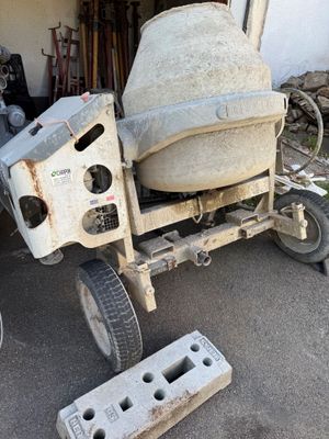 a cement mixer that is sitting in the driveway