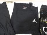 a black shirt and pants that are on a table