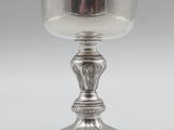 a silver cup on a pedestal on a white background