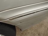 a close up of a car door handle with a hole in it