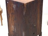 a small wooden table with a wooden chair in the background