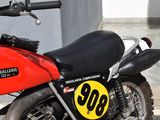 a red and black motorcycle parked on the side of the street