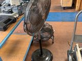 a fan that is sitting on a cart in a room