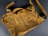 an old brown bag sitting on top of a black table