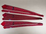 three red neck ties with white polka dots on them on a white surface