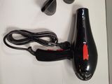 a black blow dryer and a black hair dryer on a white surface