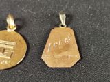 two gold coins that are sitting on a black surface