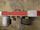 a picture of a machine with a red beam attached to it