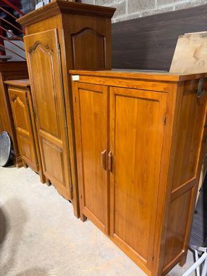 a wooden cabinet that is sitting in the middle of a room