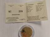 a gold coin on a white table with a receipt