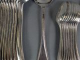 a lot of silver spoons and spoons on the table