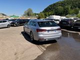 cars are parked in a parking lot with a mountain in the background