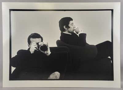 black and white photograph of a man taking a picture of himself with a camera