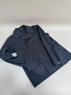 a black jacket sitting on top of a white surface