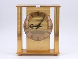 an image of a gold clock with roman numerals on the face