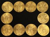 six gold sovereigns of various sizes and shapes on a black surface