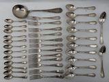 a lot of silver spoons and spoons on the table