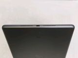 the back of a laptop computer sitting on top of a white table