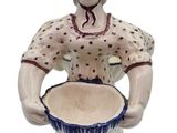 a ceramic figurine of a woman holding a bowl