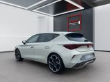 the rear end of a white car parked in a garage
