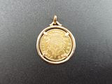a gold coin with a crown on top of it on a black surface