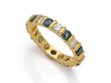 a yellow gold ring with blue and white diamonds