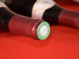 three bottles of wine sitting on a red table