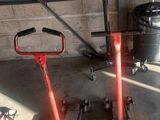 two red jacks that are sitting in a garage