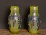 two vases that are sitting on a wooden table