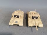 two toy tanks sitting side by side on a table