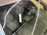 a close up of a car ' s windshield with a sticker on it
