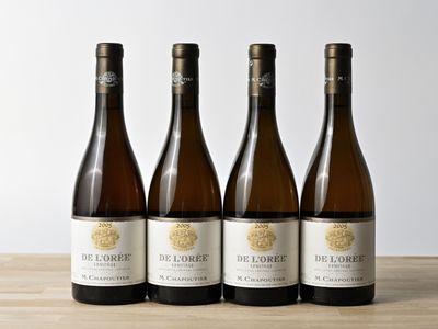 trois bouteilles de vin posées sur une table en bois