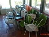 several green and white chairs are lined up in a room