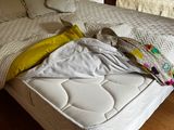 a bed that has a mattress on it in a room