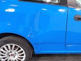 a blue car parked in a garage with its door open